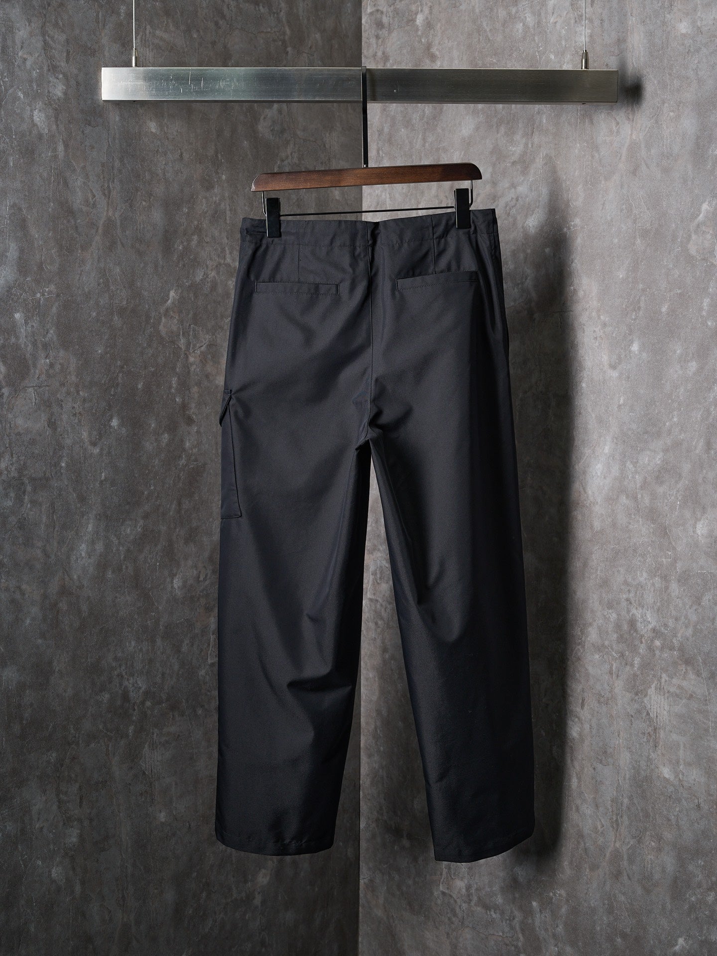 Dark tapered drawstring pants with front slash pockets and belt loops