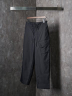 Dark wide-leg drawstring pants with front cargo-style pocket