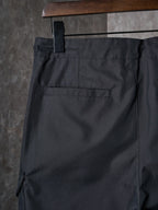 Dark pants with back welt pocket and stitched yoke panel