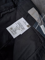 Dior pants on dark fabric, care label tag and front pocket seam detail