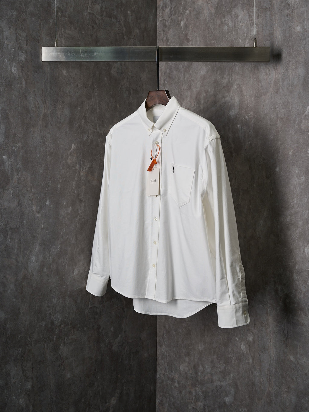 White button-up shirt with chest pocket, pointed collar, and long sleeves