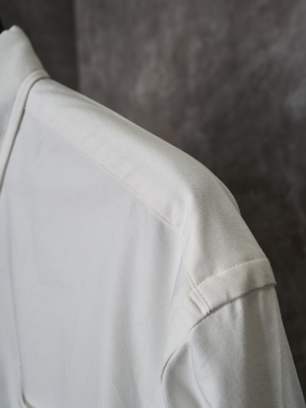 White shirt shoulder with stitched seam and textured fabric