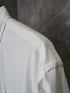White shirt shoulder with stitched seam and textured fabric