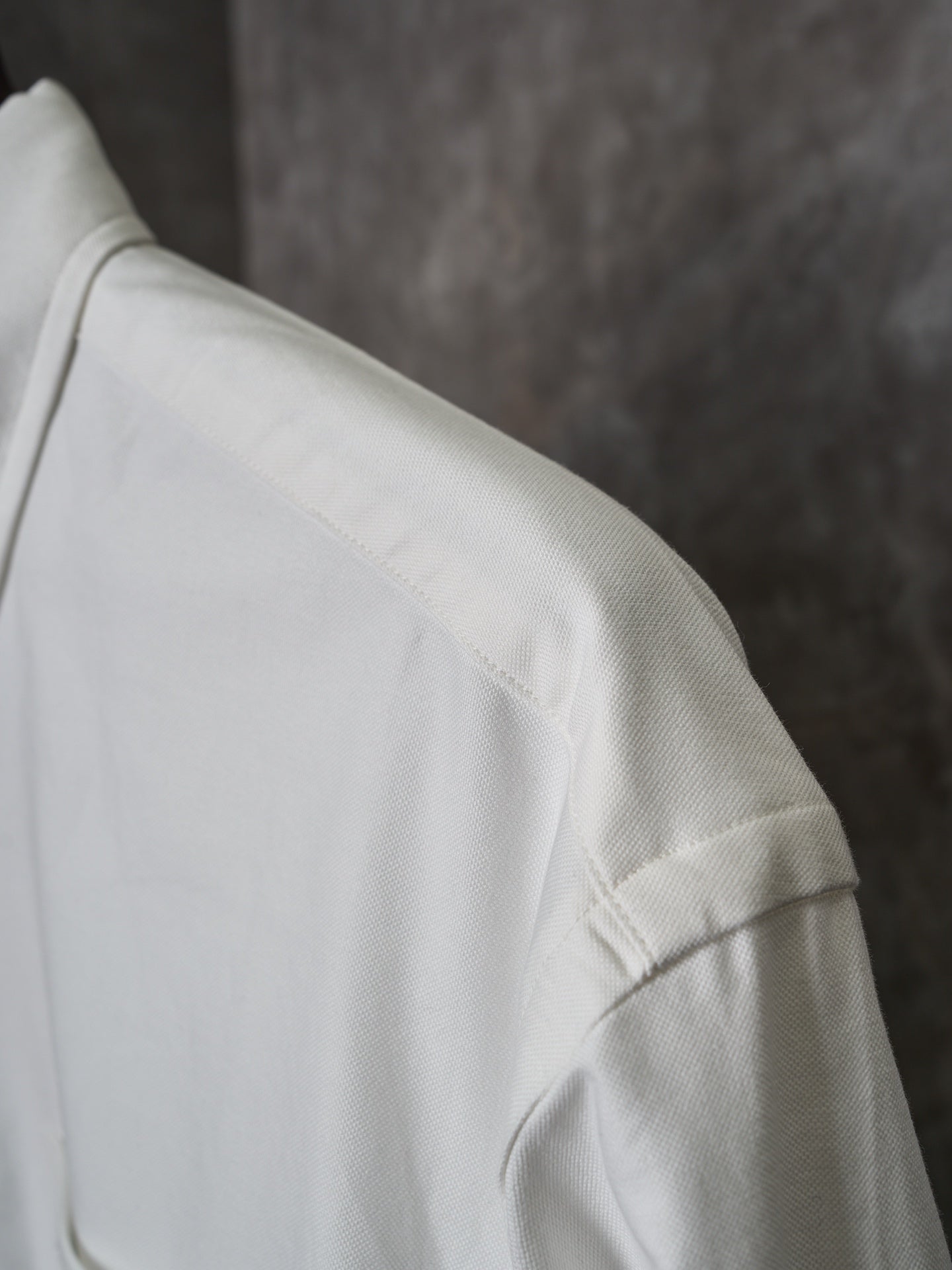 White shirt shoulder with stitched seam and textured fabric