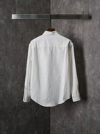 White button-up shirt with pointed collar and long sleeves