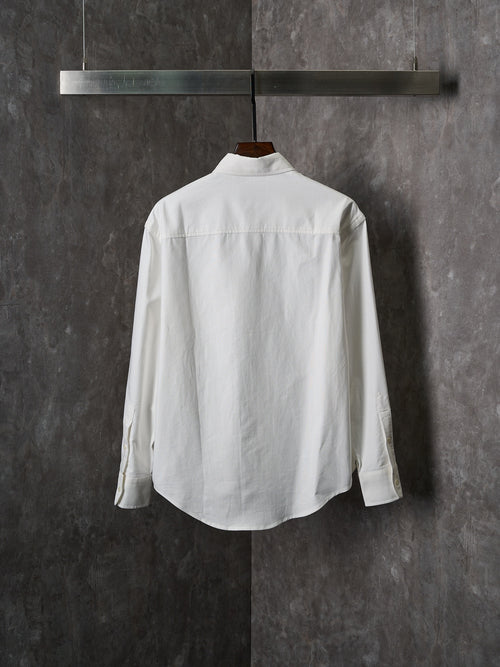 White button-up shirt with pointed collar and long sleeves