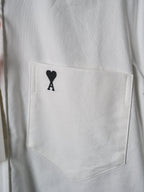 White chest pocket with black heart "A" emblem