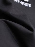 Off-White black T-shirt fabric close-up with partial logo text
