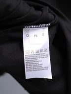 Garment care label on dark fabric collar area