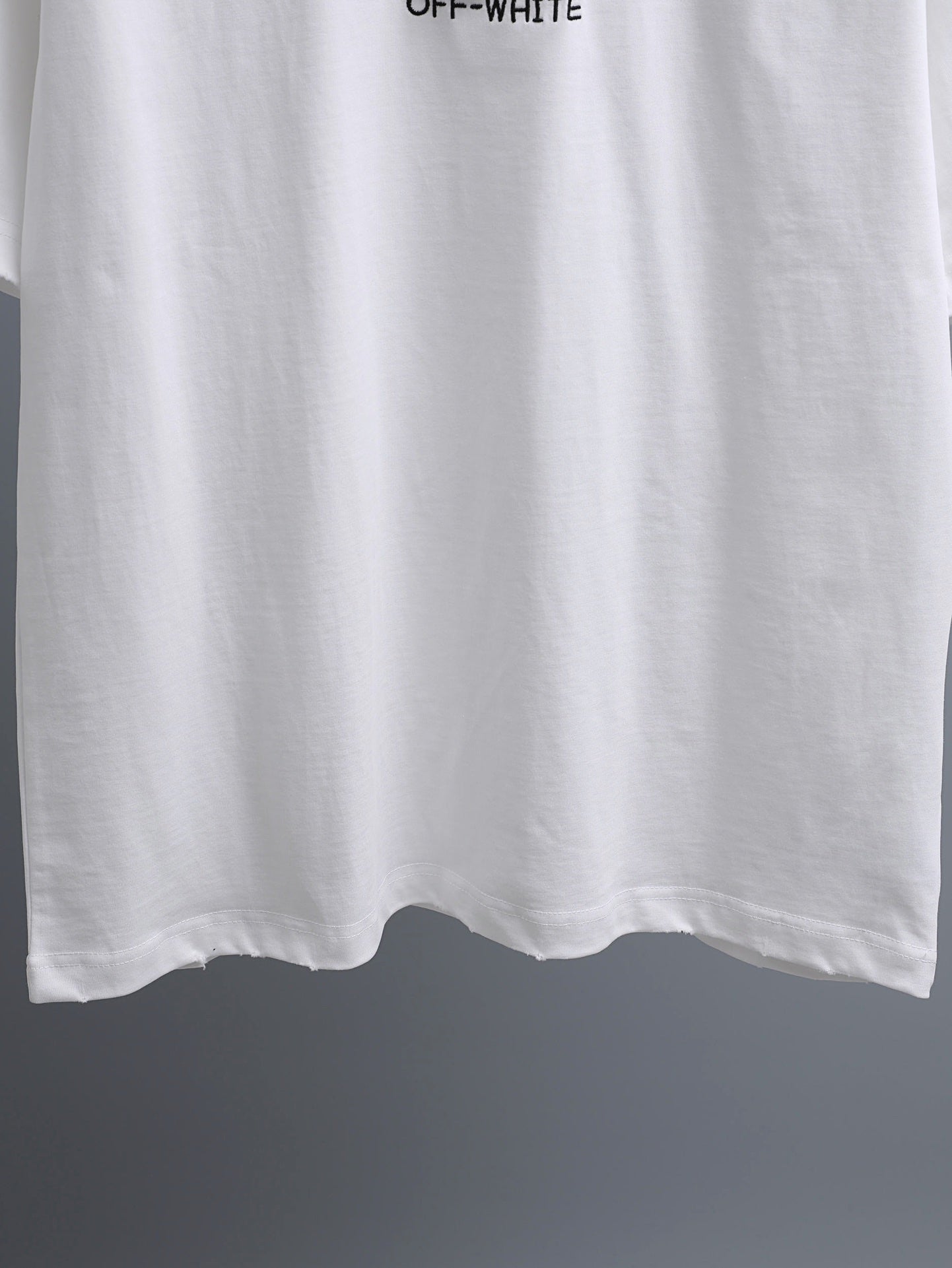 Off-White™ off white crewneck T-shirt hem with slight drape.