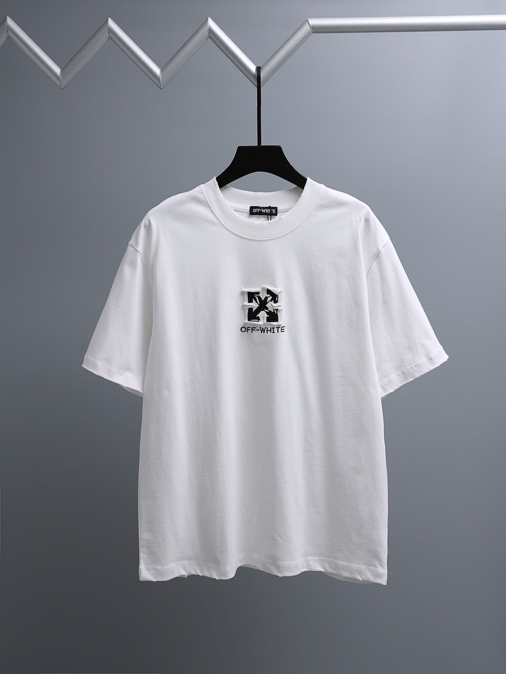 Off-White™ off white crewneck T-shirt on hanger with small chest logo print.