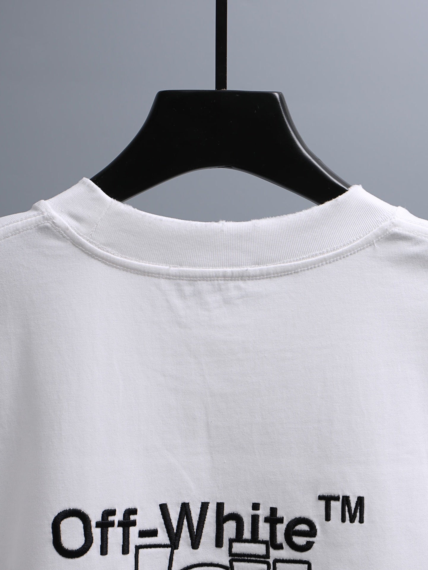 Off-White™ off white crewneck T-shirt with centered brand logo text across chest.