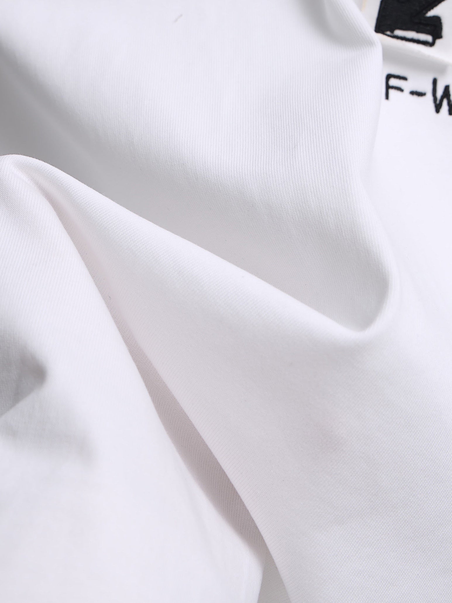 Off-White™ off white T-shirt fabric with smooth drape and seam detail.