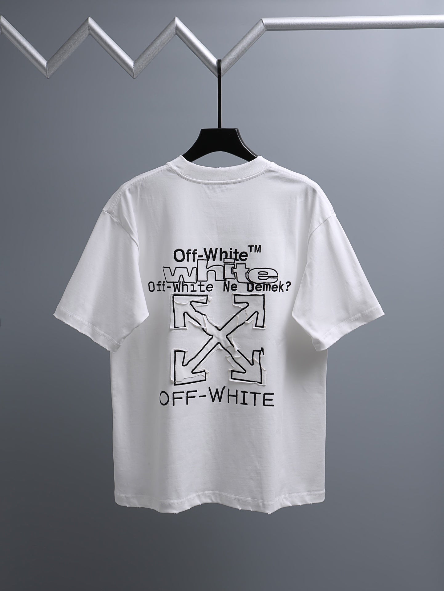 Off-White™ off white crewneck T-shirt with large graphic back print on hanger.