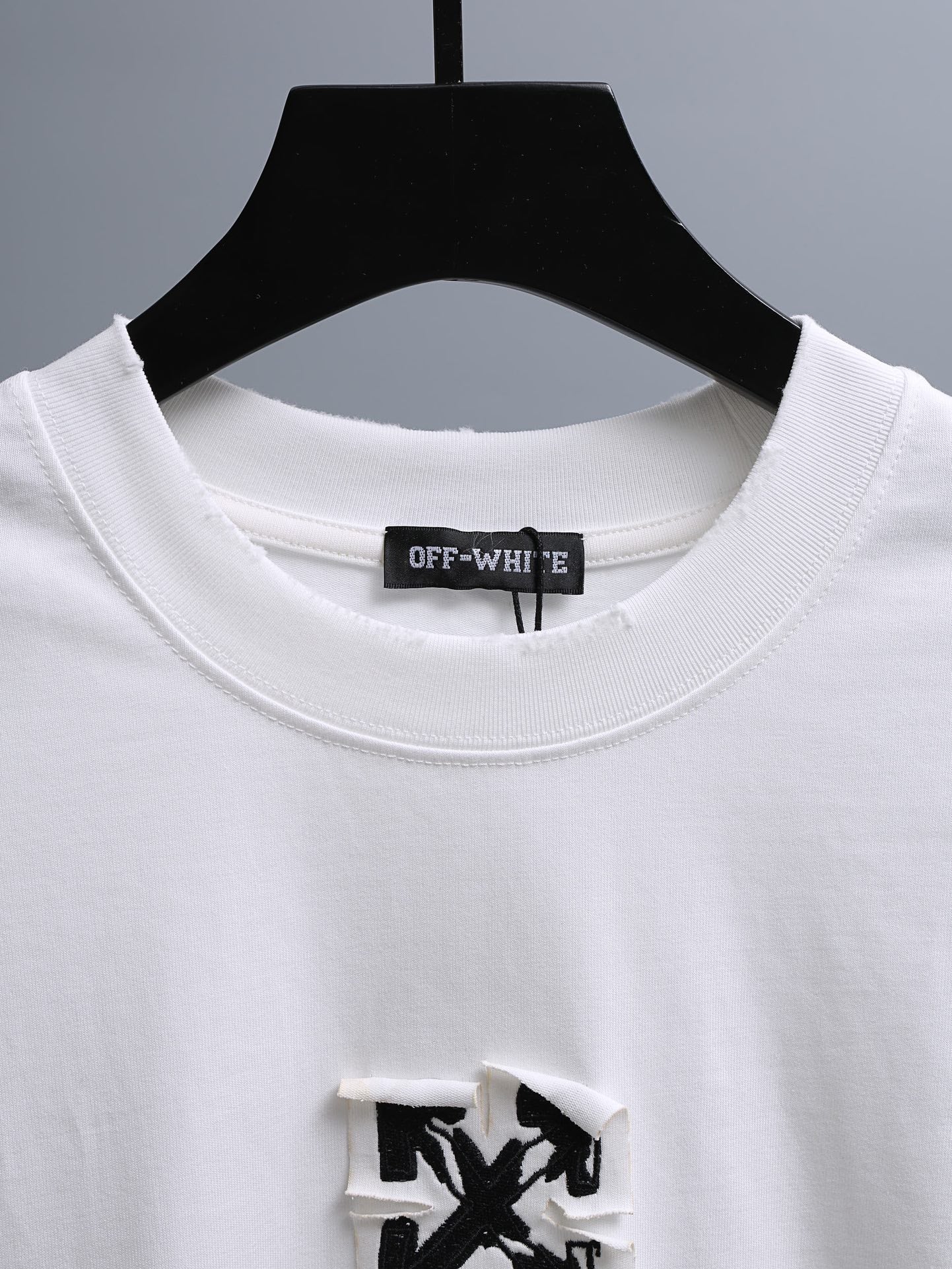 Off-White™ off white crewneck T-shirt neckline with embroidered brand label.