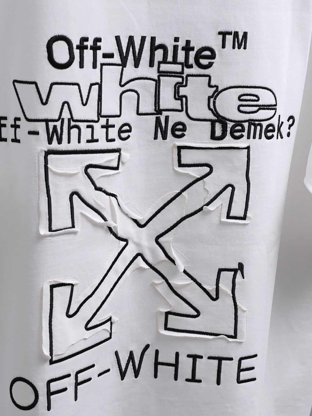 Off-White™ off white crewneck T-shirt with oversized black slogan graphic and X motif.