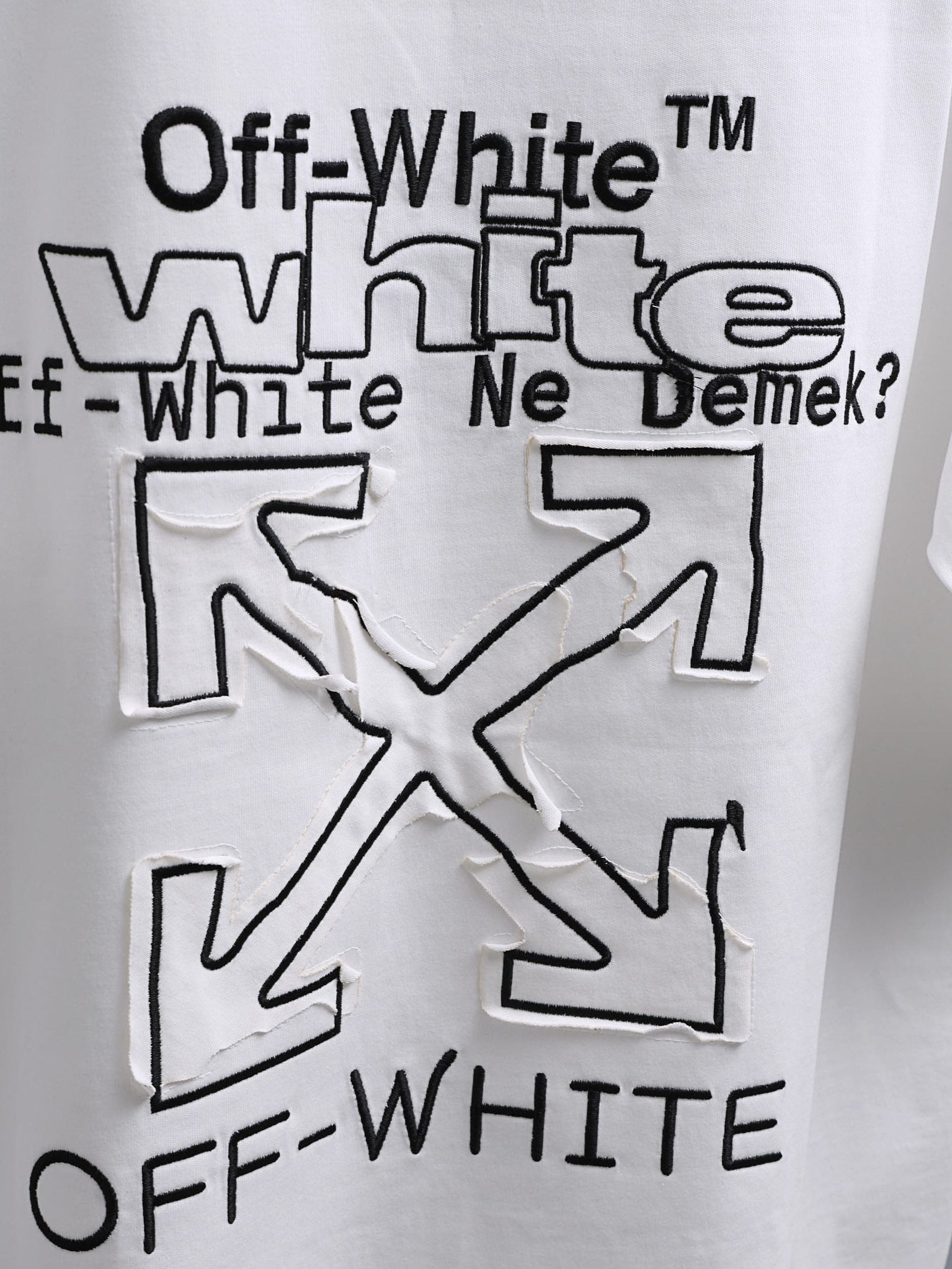 Off-White™ off white crewneck T-shirt with oversized black slogan graphic and X motif.