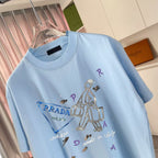 Light blue T-shirt with multicolor graphic and PRADA lettering, crew neck