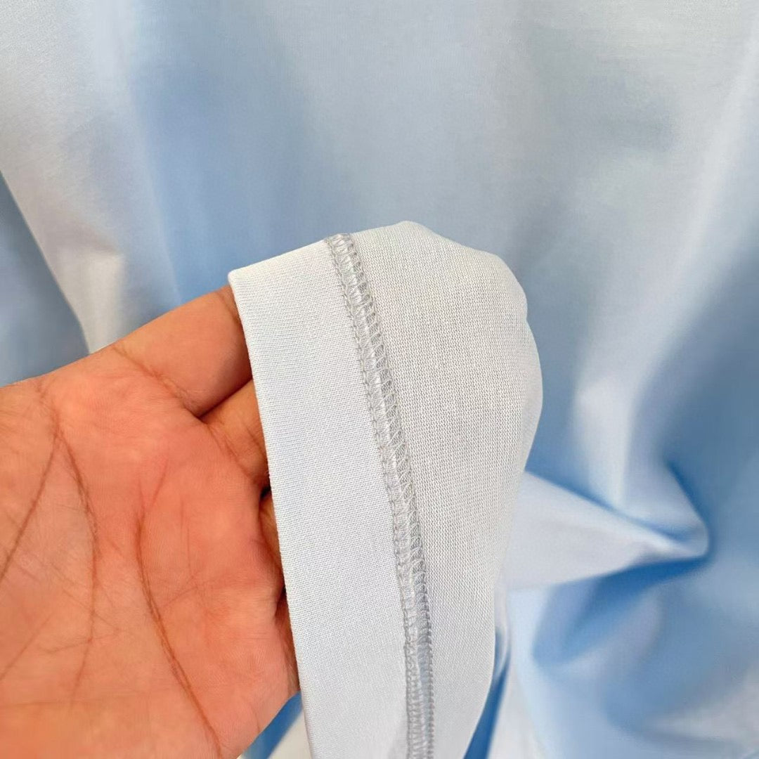 Light blue T-shirt sleeve cuff seam detail