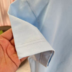 Light blue T-shirt sleeve cuff with stitched hem