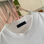 White crew-neck T-shirt with black label at collar and logo print