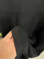 Black T-shirt fabric and side seam close-up