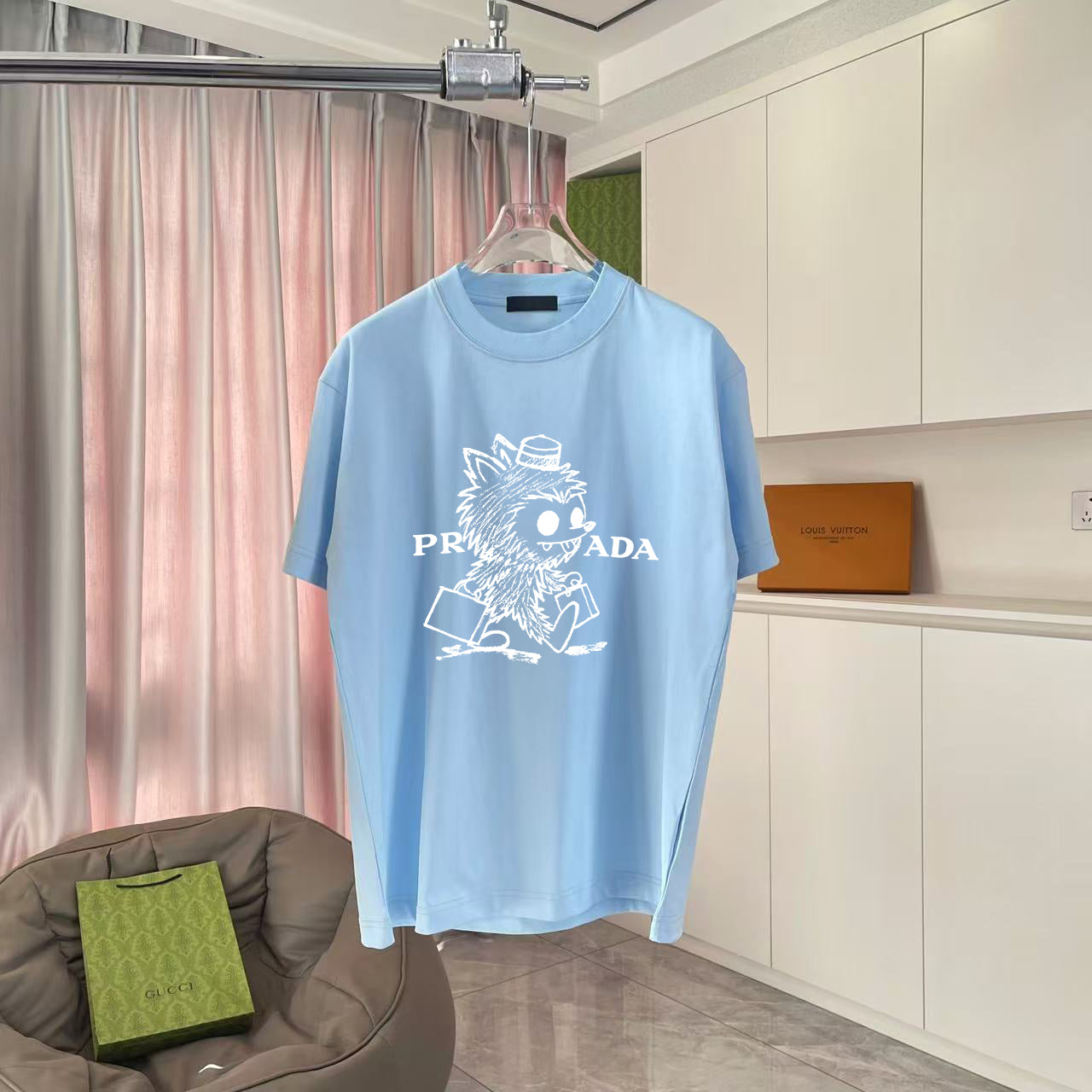 Light blue T-shirt with crew neck and white graphic print on front