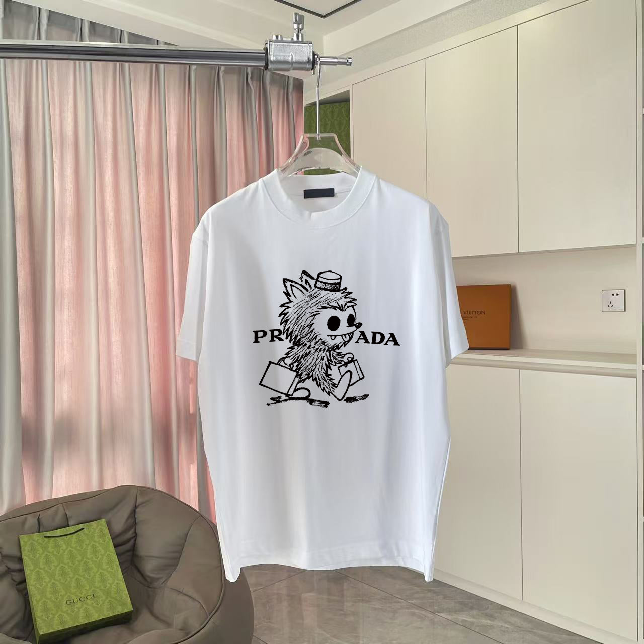 White T-shirt with cartoon graphic and PRADA-style logo print on the front