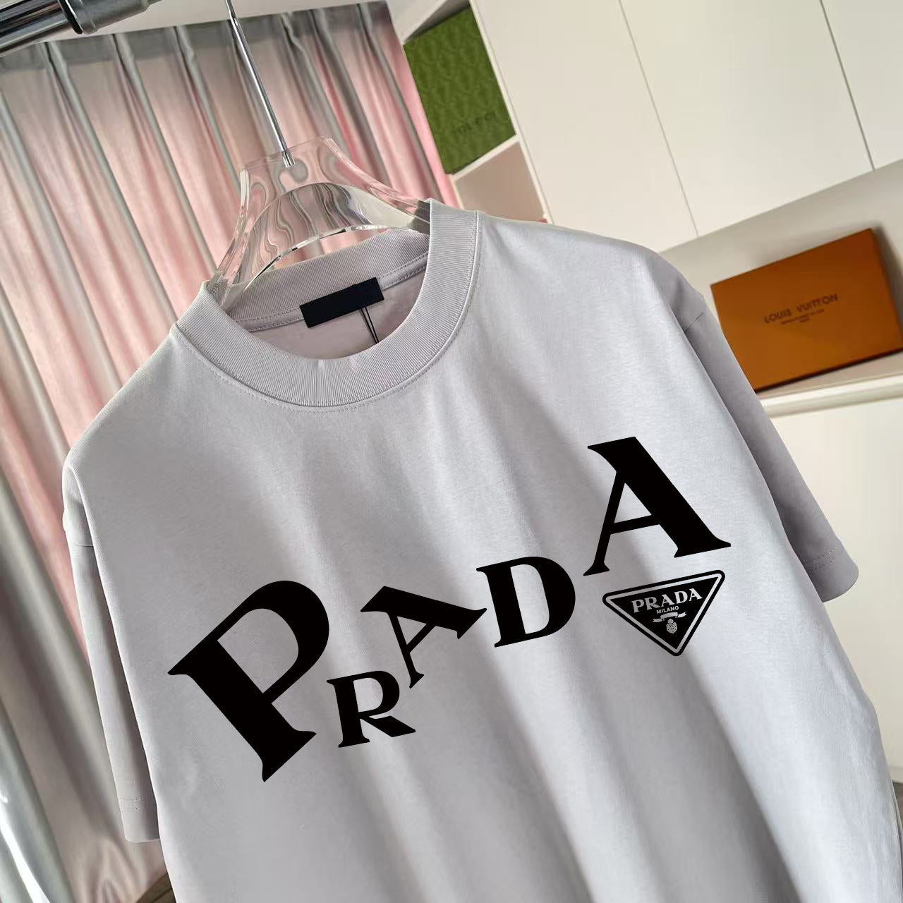 Light gray short-sleeve T-shirt with oversized Prada logo print on chest