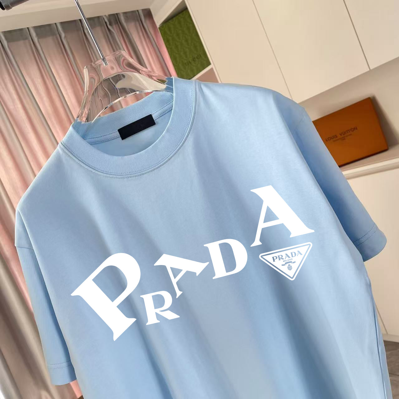 Light blue short-sleeve T-shirt close-up, front PRADA logo graphic