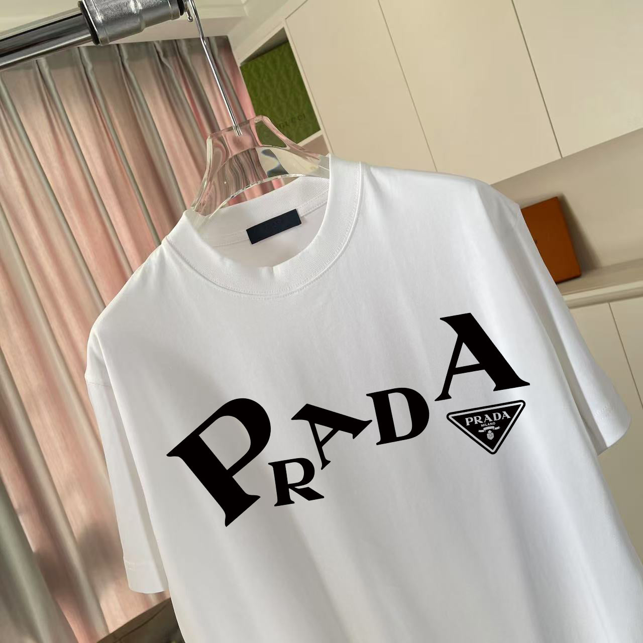 White short-sleeve T-shirt with Prada wordmark and logo patch detail