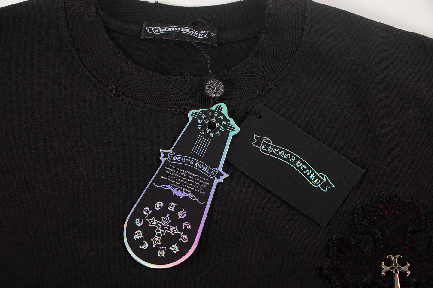 Black short-sleeve shirt neckline with tag and cross embroidery detail