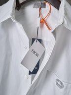 Dior white button-up shirt with orange tag string and front logo patch on chest