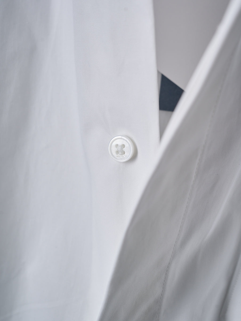 Dior white shirt button close-up on front placket