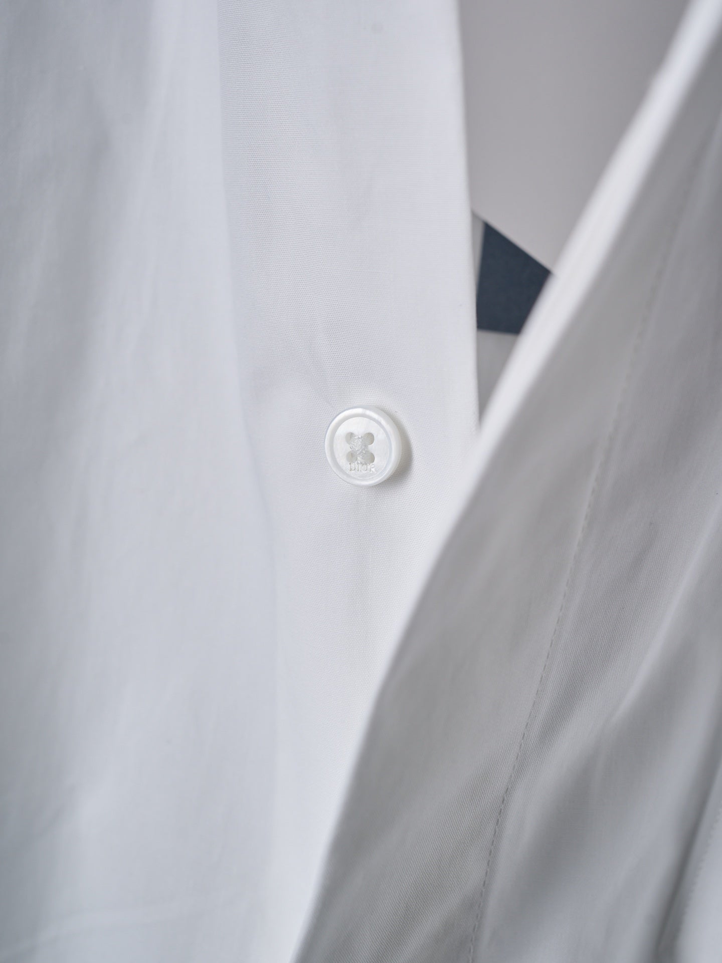 Dior white shirt button close-up on front placket