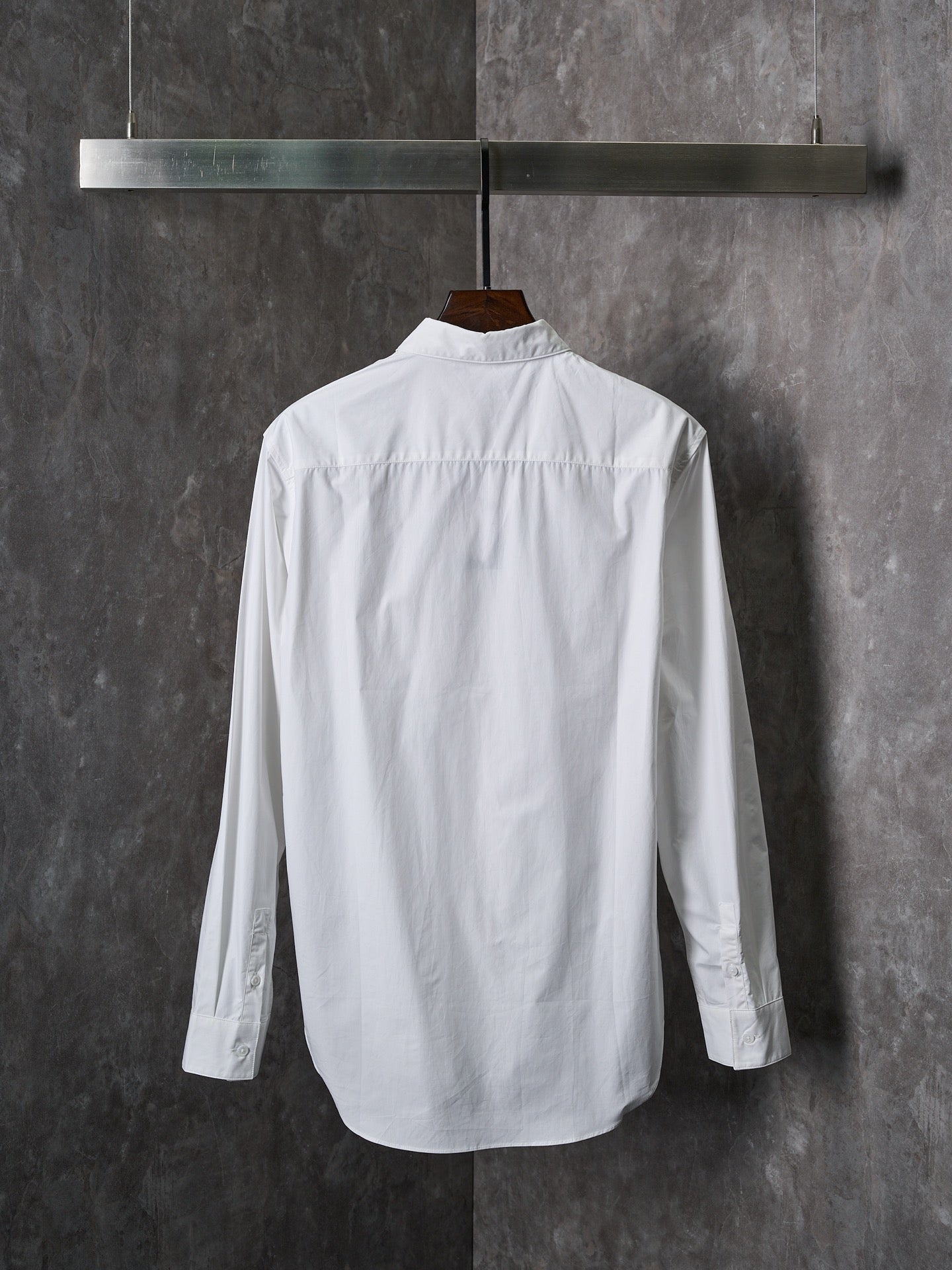 Dior white long-sleeve button-up shirt shown from the back with buttoned collar