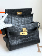 Hermes croc-textured handbags, dark blue with gold turn-lock closures, stacked view