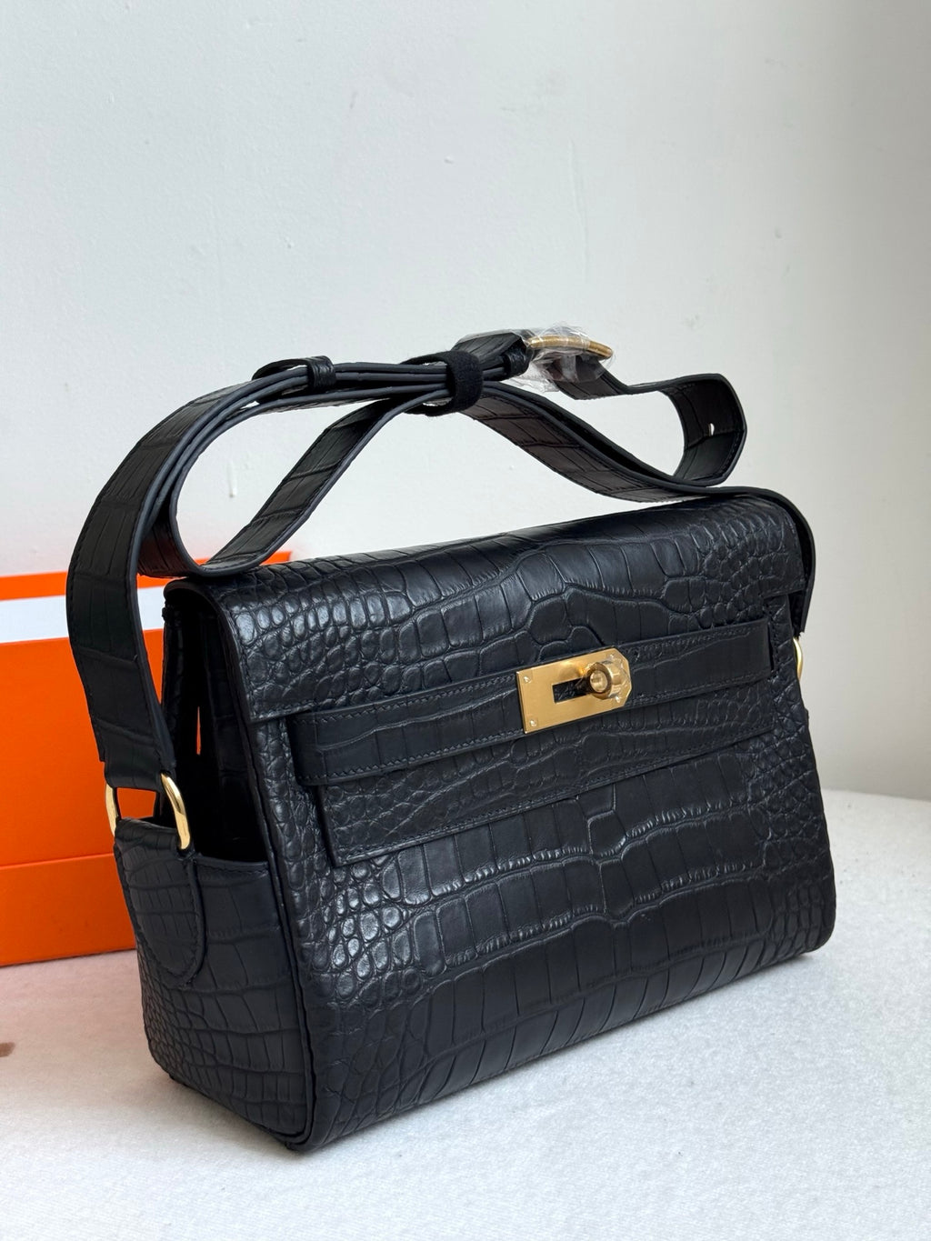 Hermes croc-textured handbag, dark blue with gold rectangular turn-lock, shoulder strap
