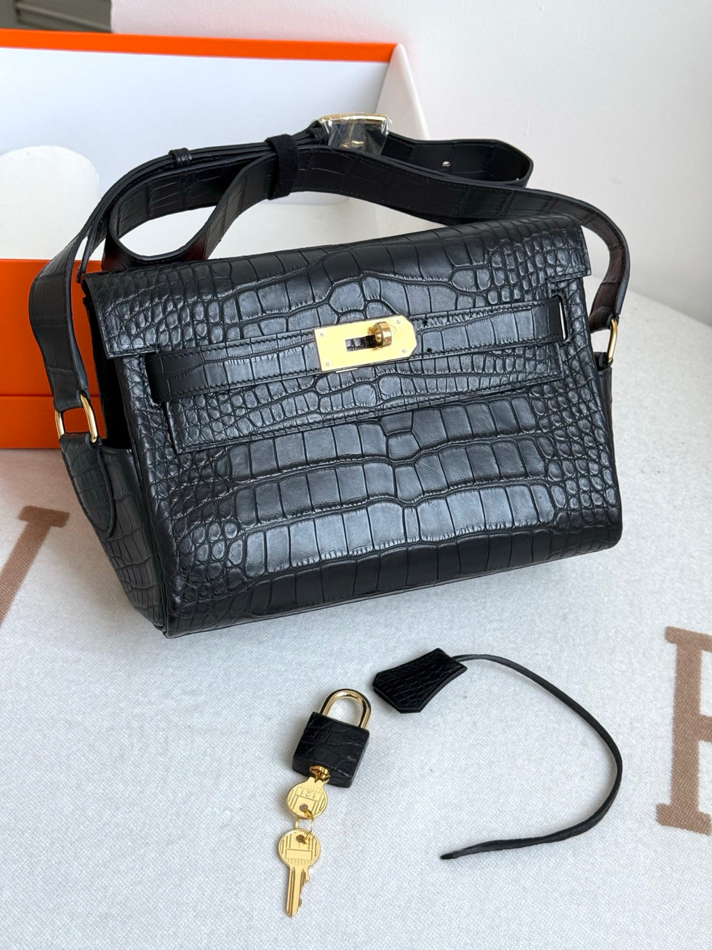 Hermes croc-textured satchel bag in dark blue, gold turn-lock, keys with strap