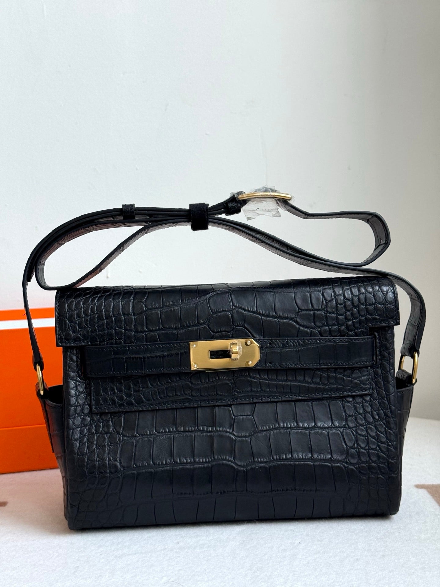Hermes croc-textured shoulder bag in dark blue, gold turn-lock clasp, top handle straps