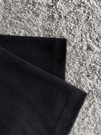 Black T-shirt hem and side seam detail