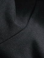 Black knit T-shirt texture near shoulder seam
