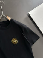 Black short-sleeve T-shirt with gold crest on chest