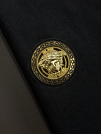 Gold crest emblem on black fabric