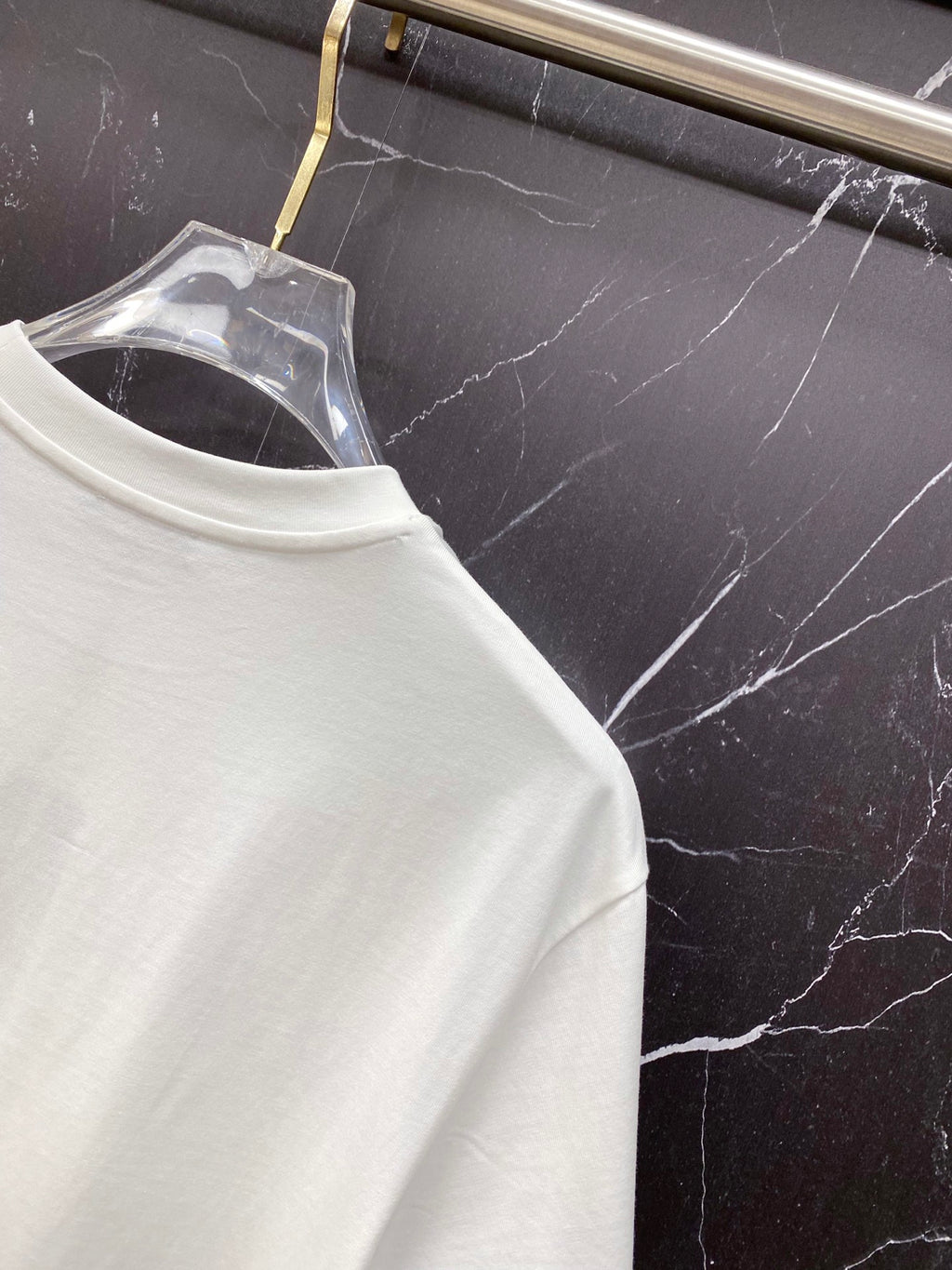 White crew-neck T-shirt collar seam close-up