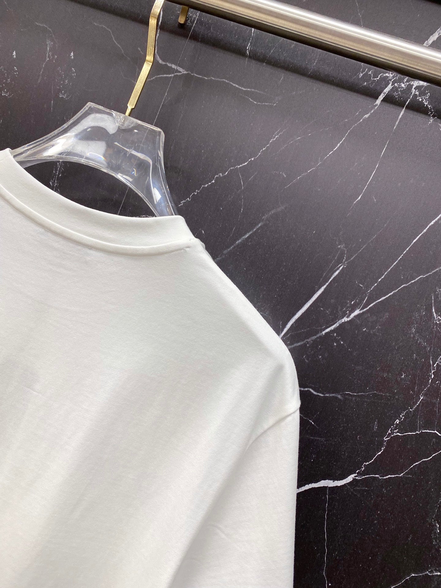 White T-shirt neckline close-up with crew neck stitching