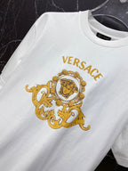 White crew-neck T-shirt with gold crest portrait logo print