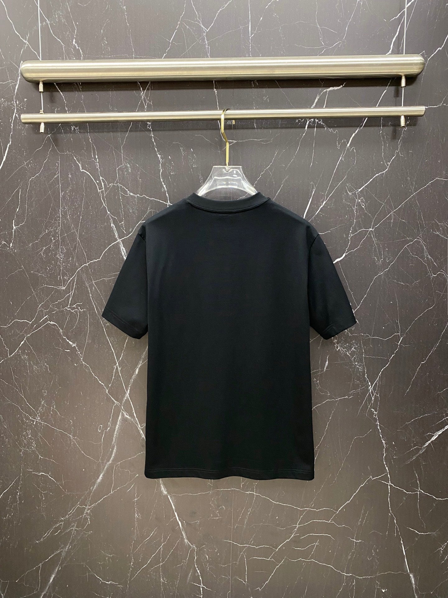 Black Versace T-shirt on hanger, plain back view.
