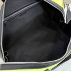 Duﬀel bag interior with black lining and silver zipper at the open top