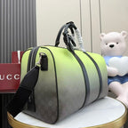 Green and gray monogram duffel bag with black shoulder strap and top zip